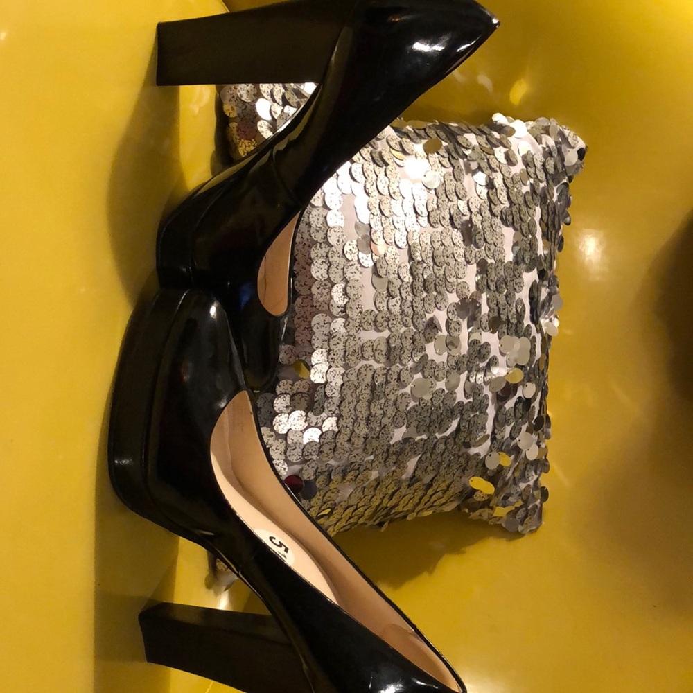Black patent leather Calvin Klein pumps.